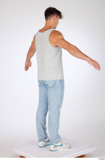 Darren a-poses blue jeans casual dressed grey tank top standing…